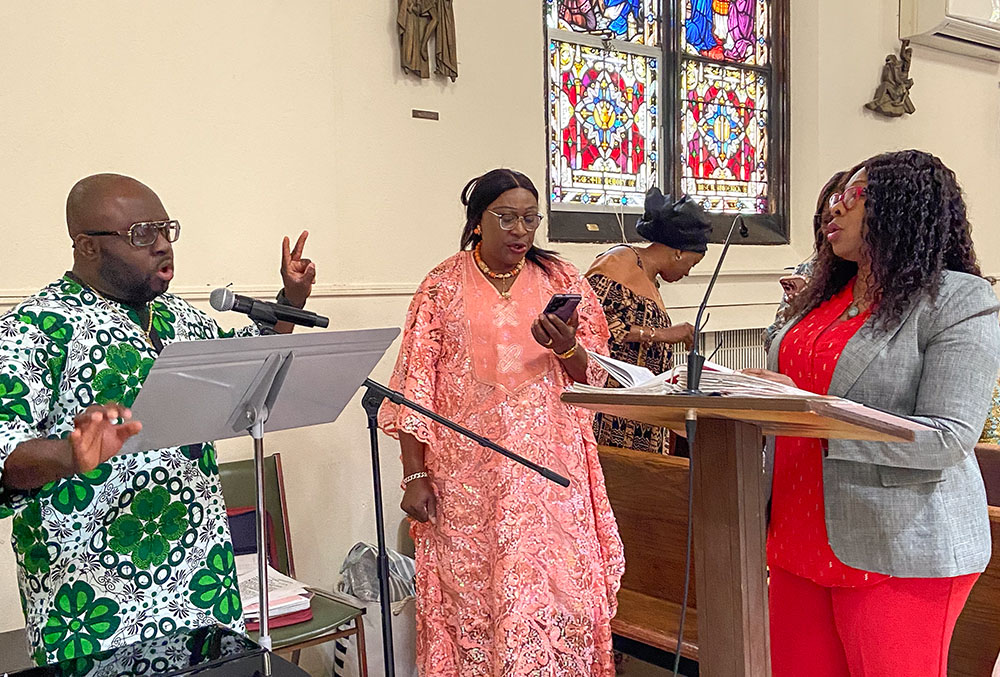 Paul Ezegamba, left, leads the choir at St. Clement Pope Church in Queens in New York City on Sunday, May 25, 2025. (Michael Aromolaran)