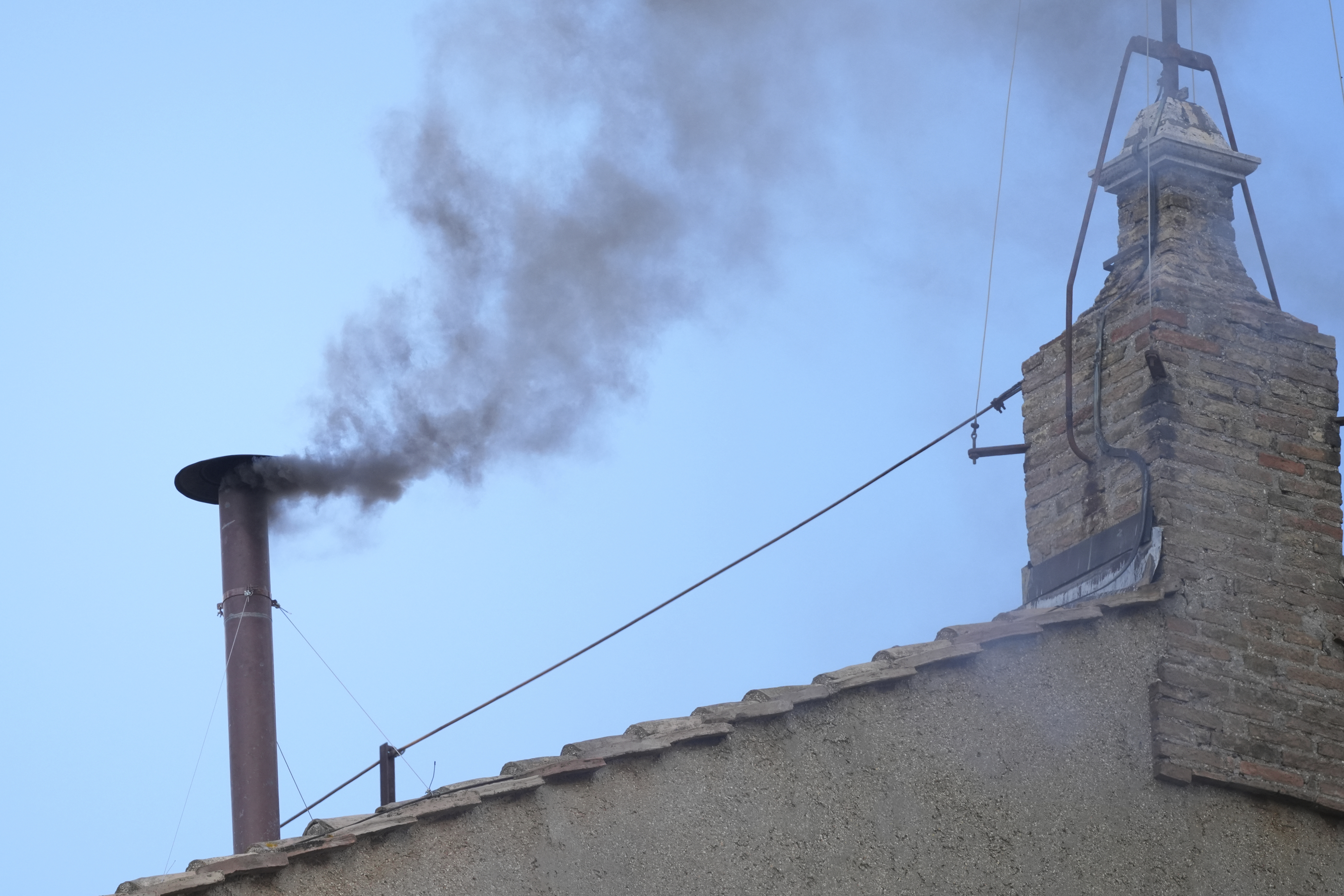 Black smoke billows from the chimney of the Sistine Chapel during the conclave to elect a new pope, at the Vatican, Thursday, May 8, 2025. (AP Photo/Andrew Medichini)