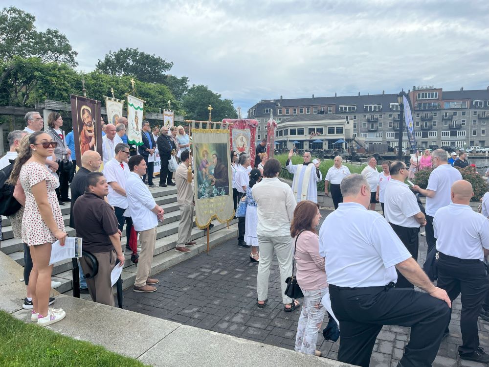 Franciscan Fr. Michael Della Penna led the crowd in the rosary before the boat arrived.