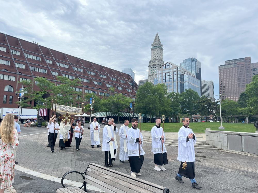 The procession walks toward the altar, with Boston's Custom House in the background. (Greta Gaffin)