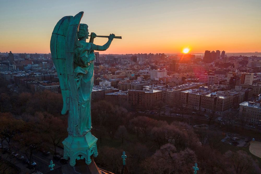 A bronze statue of the archangel Gabriel blowing a trumpet stands atop the Cathedral of St. John the Divine in N.Y.