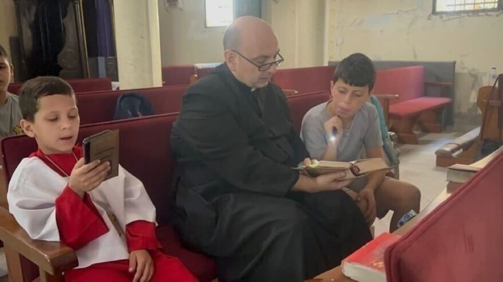 Fr. Gabriel Romanelli prays with parishioners. Fr. Gabriel Romanelli prays with parishioners.