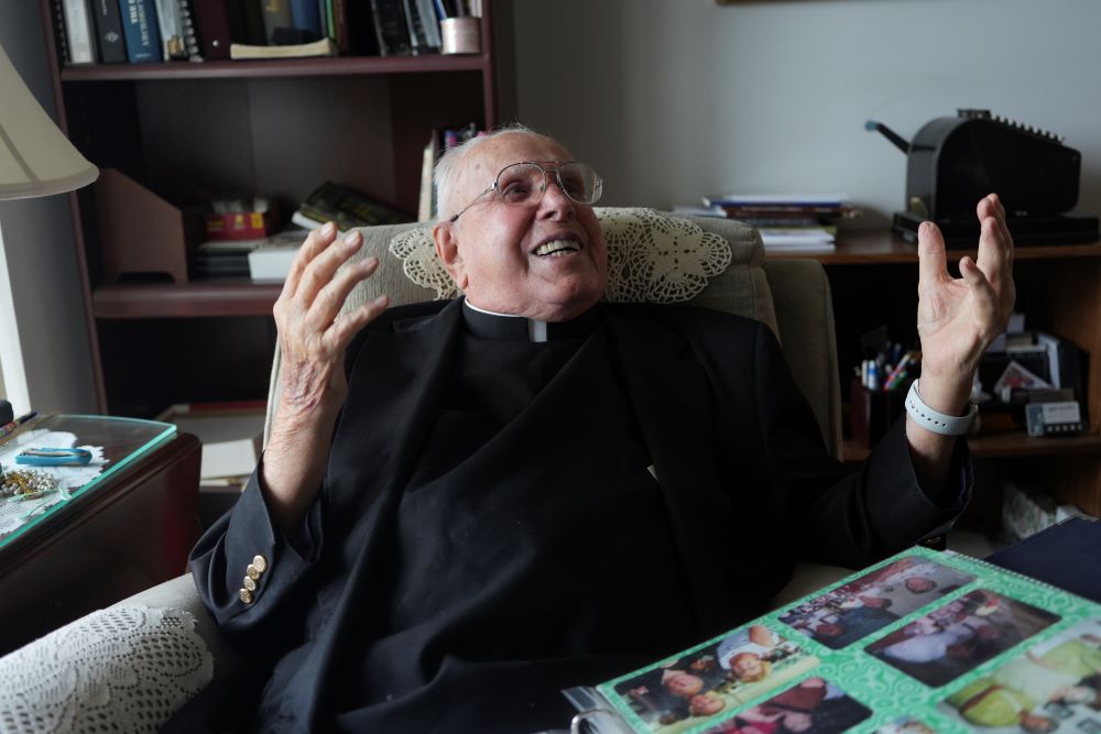 Fr. James Kelly laughs during an interview at his apartment.