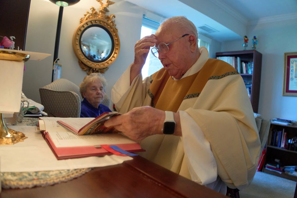 Fr. James Kelly celebrates Mass at his apartment. 