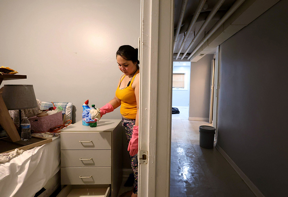 Patricia Medina cleans her flood-damaged apartment along the 1900 block of South 51st Court in Cicero, Illinois, on July 3, 2023. After the flooding, longtime residents of Cicero and Berwyn started a grassroots community organizing group to respond to the area's environmental concerns. (Stacey Wescott/Chicago Tribune/TNS)