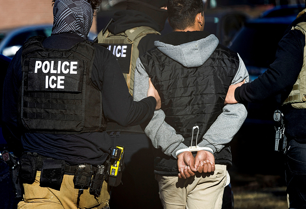 Agents with the Immigration and Customs Enforcement detain a man after conducting a raid at the Cedar Run apartment complex in Denver on Feb. 5, 2025. (OSV News/Reuters/Kevin Mohatt)