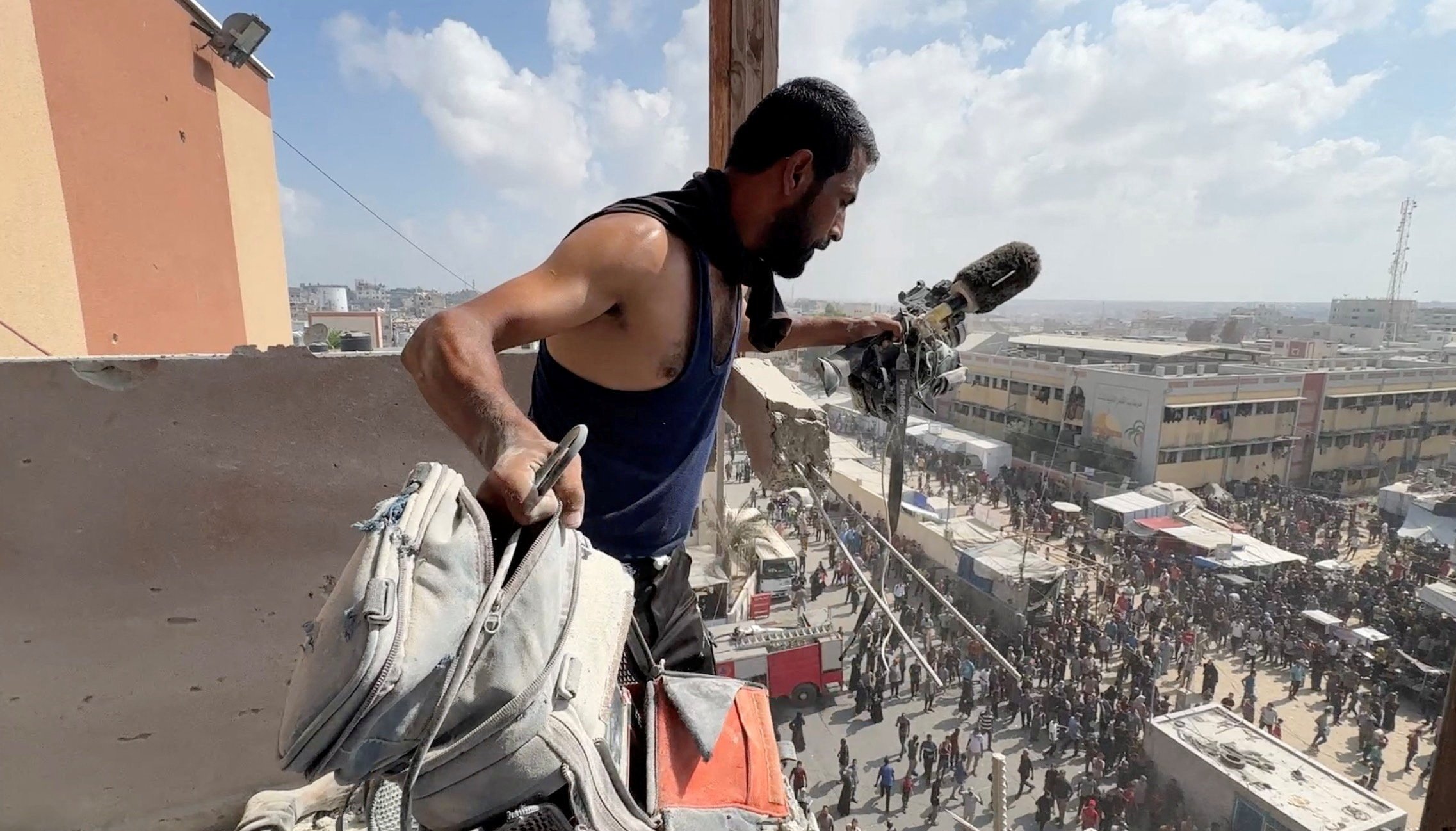 A man holds the equipment used by Palestinian cameraman