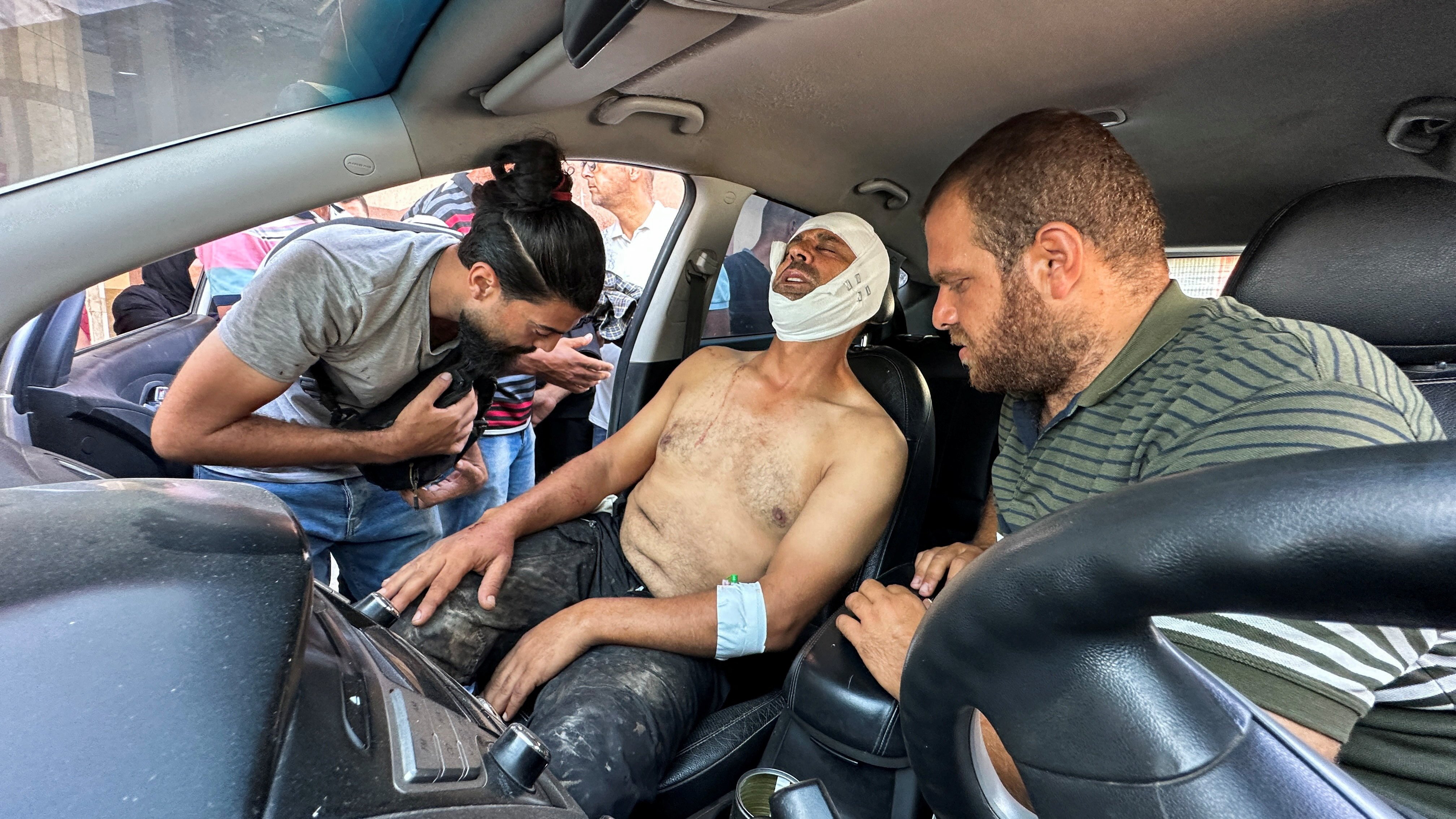 Photographer Hatem Khaled, a Reuters contractor, sits in a car, after being wounded in Israeli strikes on Nasser Hospital in Khan Younis in the southern Gaza Strip, Aug. 25, 2025, that killed journalists, including Reuters contractor and cameraman Hussam al-Masri. (OSV News photo/Ramadan Abed, Reuters)