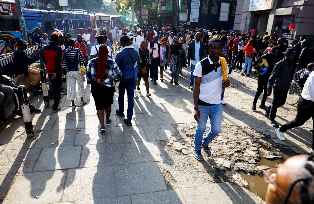 Pedestrians walk on street in Nairobi.