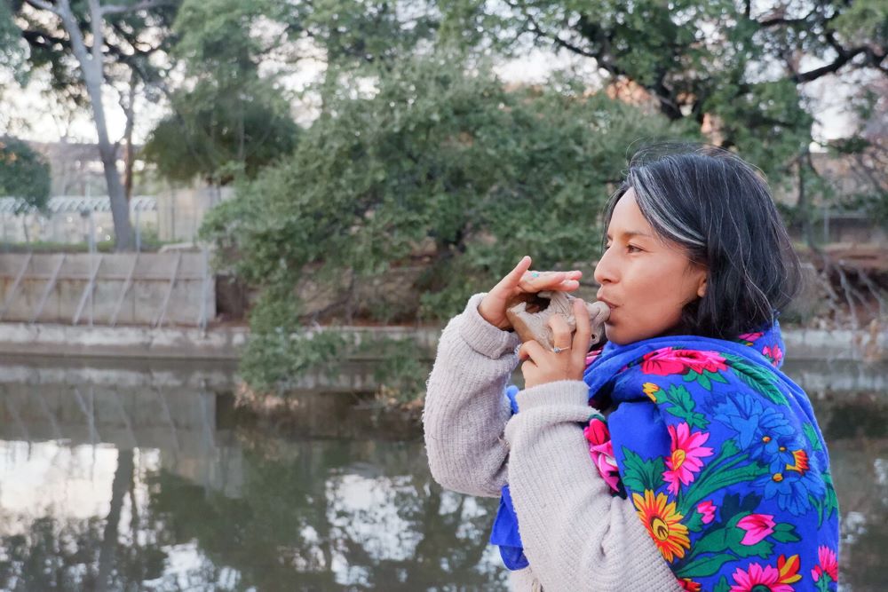Excy Guajardo blows a jaguar whistle, as a representation of the panther's roar in a Coahuiltecan creation story, along the San Antonio River in Brackenridge Park.