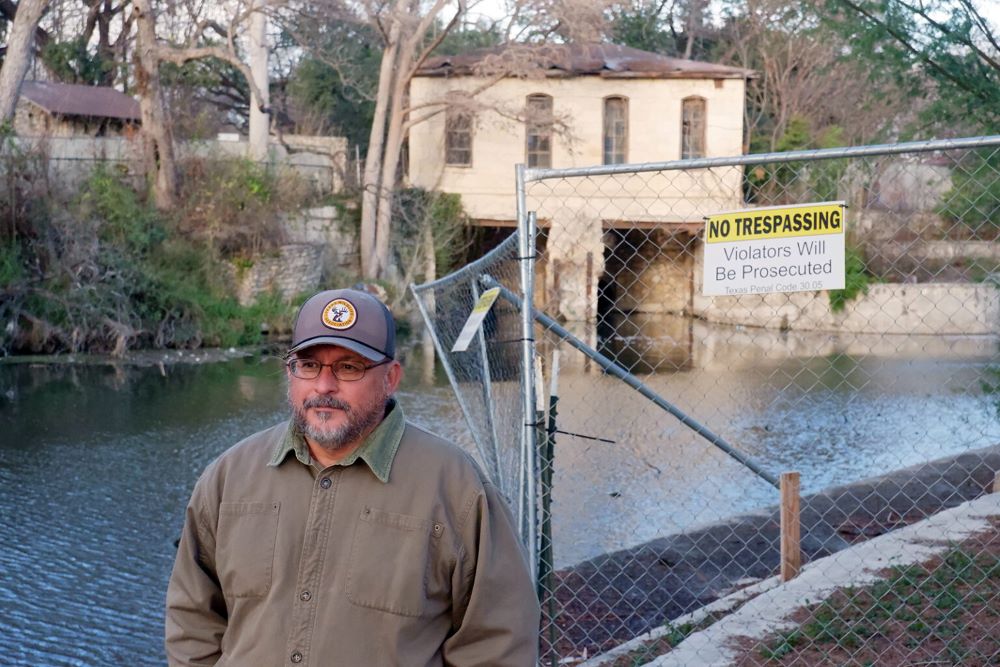 Gary Perez poses for a portrait next to the San Antonio River 
