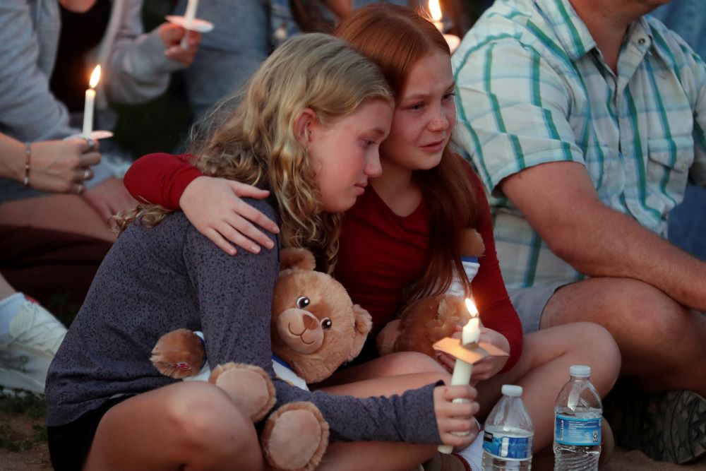 People gather at a vigil at Lynnhurst Park after a fatal shooting at the Annunciation Catholic School Aug. 27 in Minneapolis. Two children were killed and 18 people injured in the attack. (AP/Bruce Kluckhohn)