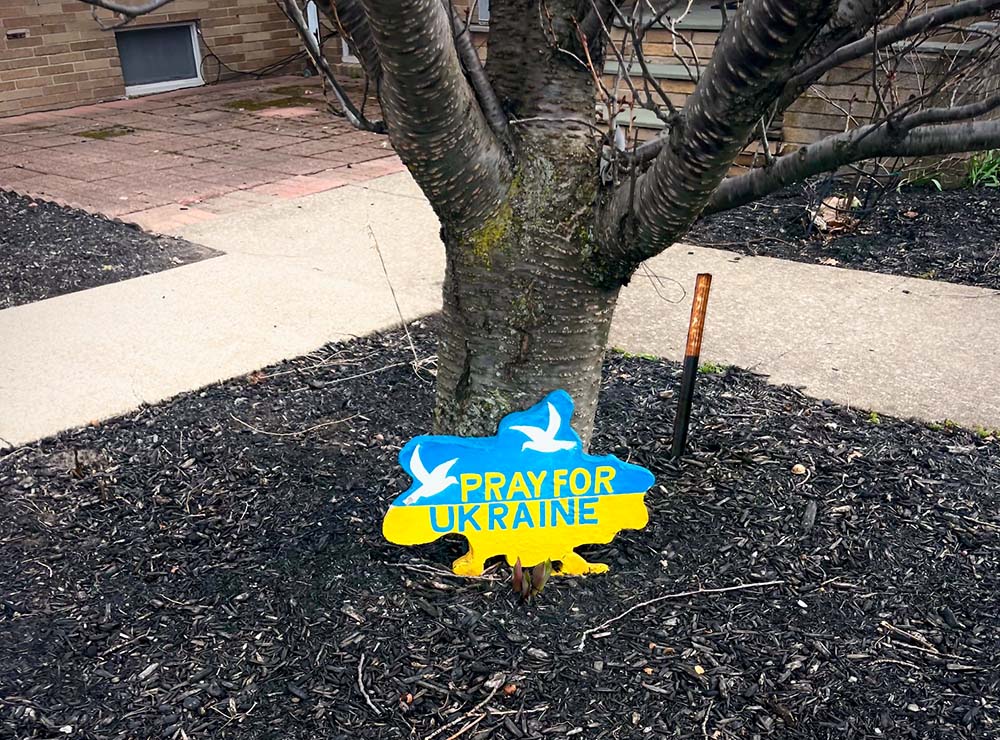 A sign outside St. Josaphat's Ukrainian Catholic Church in Irondequoit, N.Y., carries the hopes and prayers of the community. (George Payne)