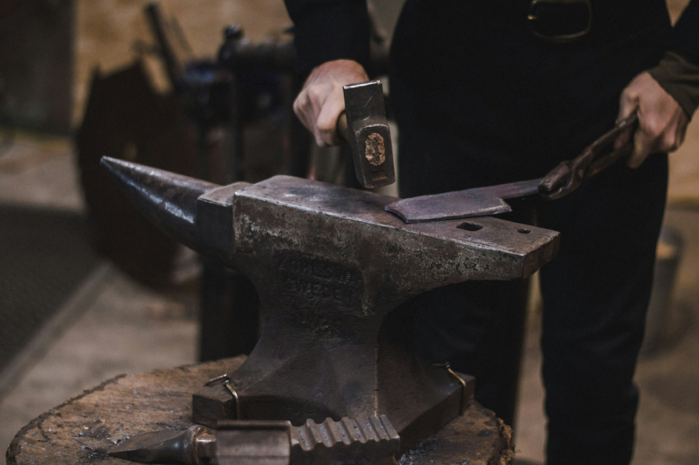A blacksmith hammering metal