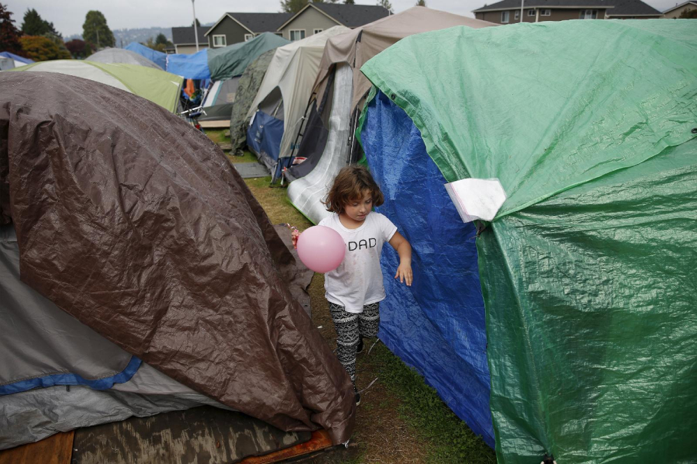 A child is pictured in a file photo playing with a ball at a homeless encampment in Seattle.