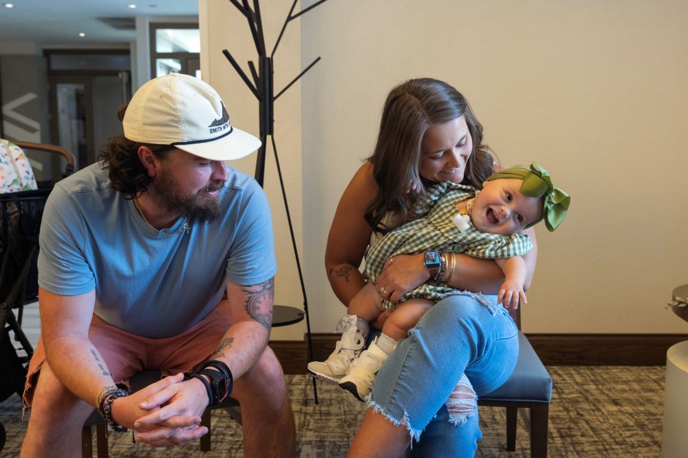 Bryan and Taylor McClain sit with their daughter, Violette. 