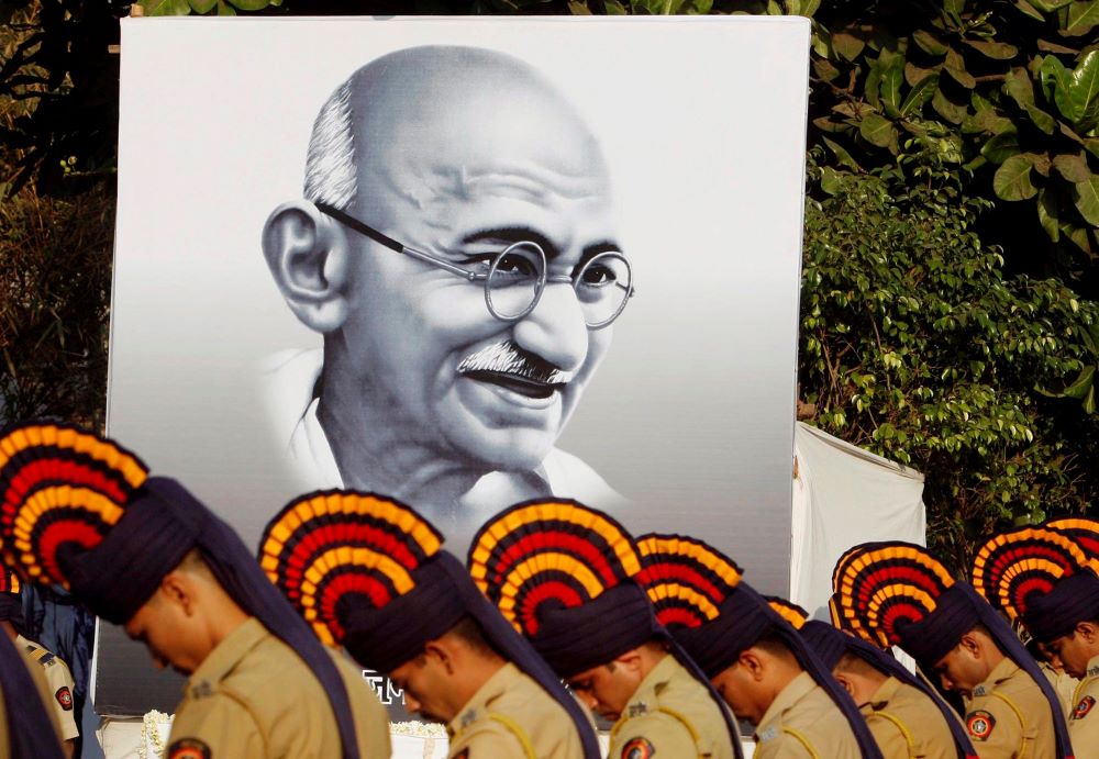 Police pay homage to Mohandas Gandhi near Mumbai, India, Jan. 30, 2008, the 60th anniversary of his assassination. 
