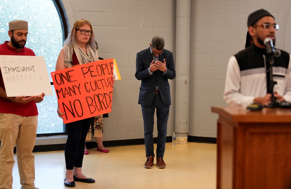 Ayman Soliman, third from left, prays with others at the close of a news conference, after being released from ICE Custody, at the Clifton Mosque in Cincinnati on Sept. 19. (AP/Carolyn Kaster)