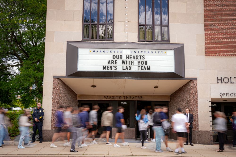 An overflow crowd packed the theater and lobby of Marquette University's Varsity Theatre for a memorial Mass for two college lacrosse players killed in a crash by alleged drunken driver Sept. 6. (Clay Ellis-Escobar)