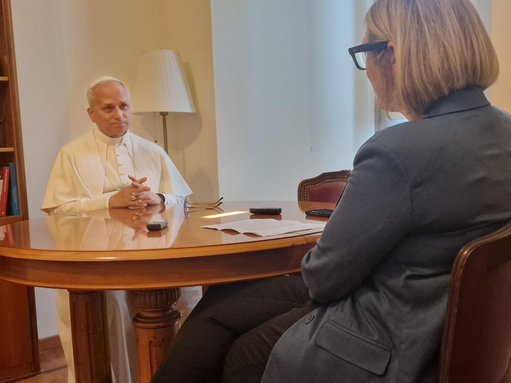 Pope Leo XIV sits with Elise Allen, senior correspondent at Crux, for an interview at the pope's residence inside the Vatican's Palazzo Sant'Uffizio July 30, 2025. (CNS/courtesy Crux)