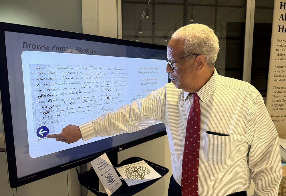 Raymond Moore studies an interactive exhibit displaying the family tree of Pope Leo XIV, his distant cousin, Oct. 3 at the American Ancestors building in Boston. (NCR photo/Brian Fraga)