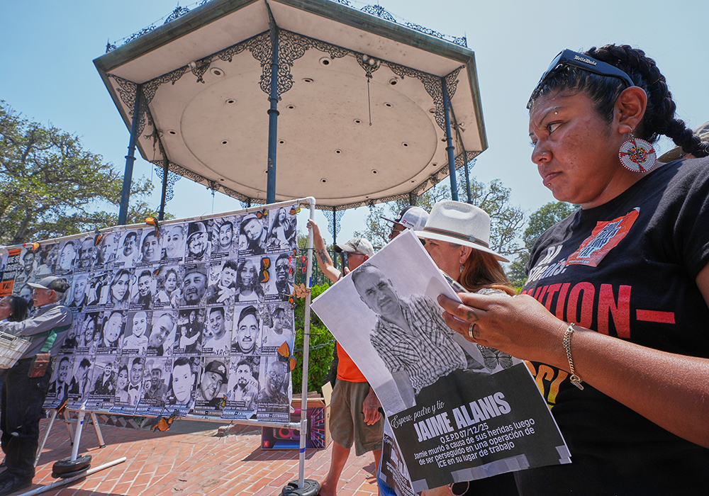 Activist and farm worker Xochitl Nunez, right, holds up a picture of late farm worker Jaime Alanis, believed to be the first fatality during an ICE immigration raid, as she joins farmworkers, immigrant leaders, labor allies, and organizers to announce a national "Farmworker Strike for Dignity" during a news conference at La Placita Olvera in Los Angeles, July 14, 2025. (AP photo/Damian Dovarganes)