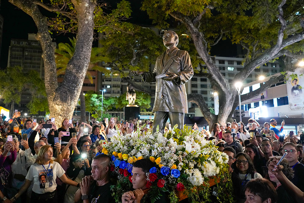 In Caracas, Venezuela, Oct. 19, 2025, believers carry a statue of José Gregorio Hernández during an event to celebrate his canonization. (AP/Ariana Cubillos)