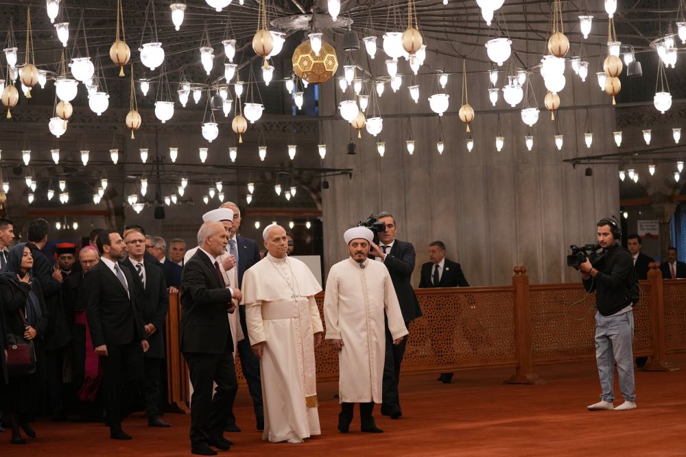 Pope Leo XIV, center, walking with Muezzin Musa Asgın Tunca, left, Dr. Emrullah Tuncel, second from left, and Imam of Mosque Sultanahmet Fatih Kaya, visits the Sultan Ahmed Mosque in Istanbul Nov. 29. 