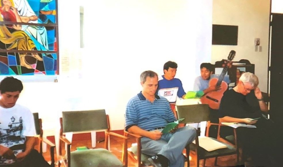 Augustinian Fr. Robert Prevost prays in the chapel of St. Thomas of Villanova convent in Trujillo, Peru, in an undated photo. Seated front right is Augustinian Fr. John Lydon. 