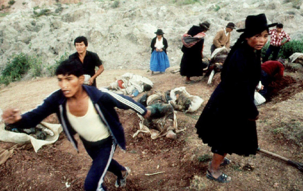 A bride turns away from a mass grave in the rural village of Soccos, Peru, in this file photo from 1983.