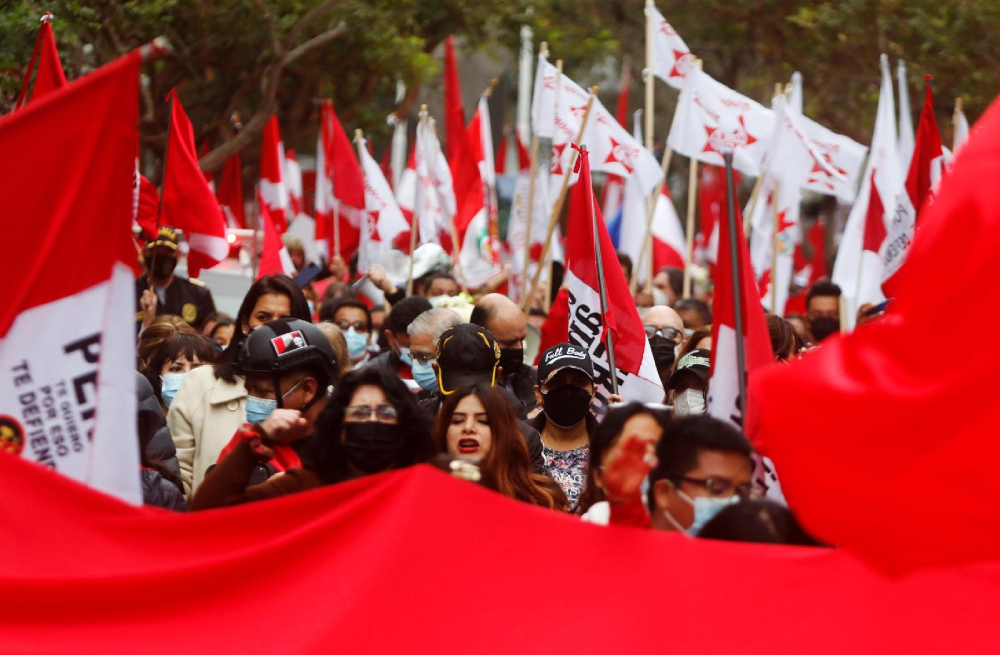 People gather Sept. 12, 2021, in Lima, Peru, to commemorate the 29th anniversary of the capture of Abimael Guzmán, founder of Peruvian rebel group Sendero Luminoso (Shining Path). Guzmán died Sept. 11 at the Callao Naval Base, where he was serving two life sentences. (CNS/Reuters/Sebastian Castaneda)