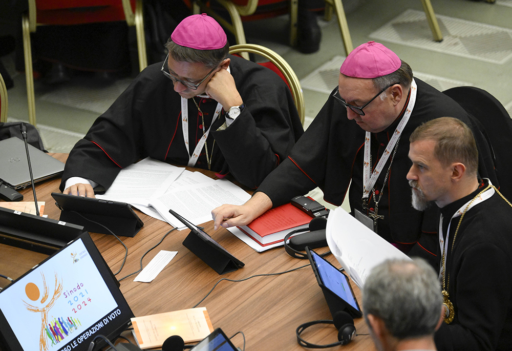 Members of the assembly of the Synod of Bishops use tablets to vote on the gathering's synthesis document Oct. 28, 2023, in the Paul VI Hall at the Vatican. (CNS/Vatican Media)
