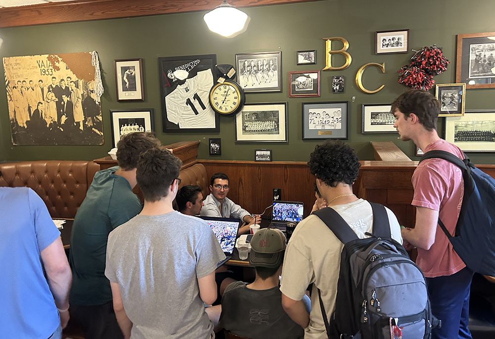 Students at Benedictine College in Atchison, Kansas, watch the announcement of a new pope at a coffee shop May 8. Chicago-born Cardinal Robert Francis Prevost was elected as the next pope and he chose the papal name Leo XIV. (OSV News/Jack Figge)