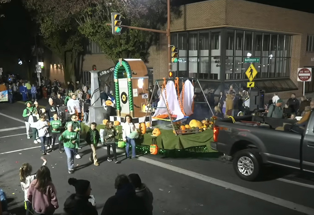 This is a screenshot of a St. Joseph Catholic School float in the Hanover Halloween Parade held Oct. 30, 2025 in Hanover, Pennsylvania. The float includes what appears to be a replica of one of the main gates at Auschwitz concentration camp, including the phrase "Arbeit macht frei." Bishop Timothy C. Senior of the Diocese of Harrisburg apologized for the float in a statement dated Oct. 31, 2025. (OSV News screenshot/Community Media of South Central PA via YouTube)