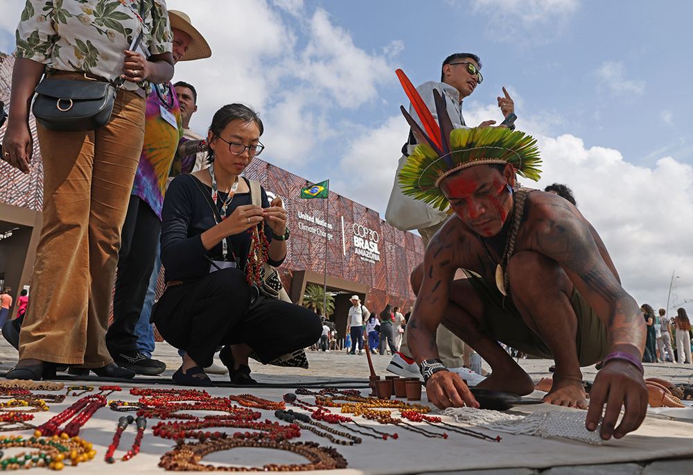Indigenous people sell products at the entrance to the blue zone at the COP30 United Nations climate change conference in Belém, Brazil on Nov. 12. (COP30/Sergio Moraes)
