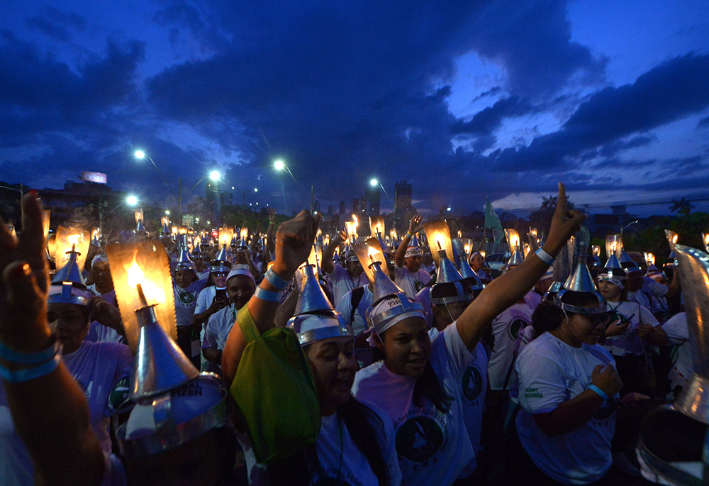Activists take part in the "Porongaço" march of the Forest Peoples in Belém, Brazil, during the COP30 United Nations climate change conference on Nov. 13. The name "Porongaço" comes from the poronga, the oil lamp used by rubber tappers during their night work in the forest. (COP30/Ueslei Marcelino)