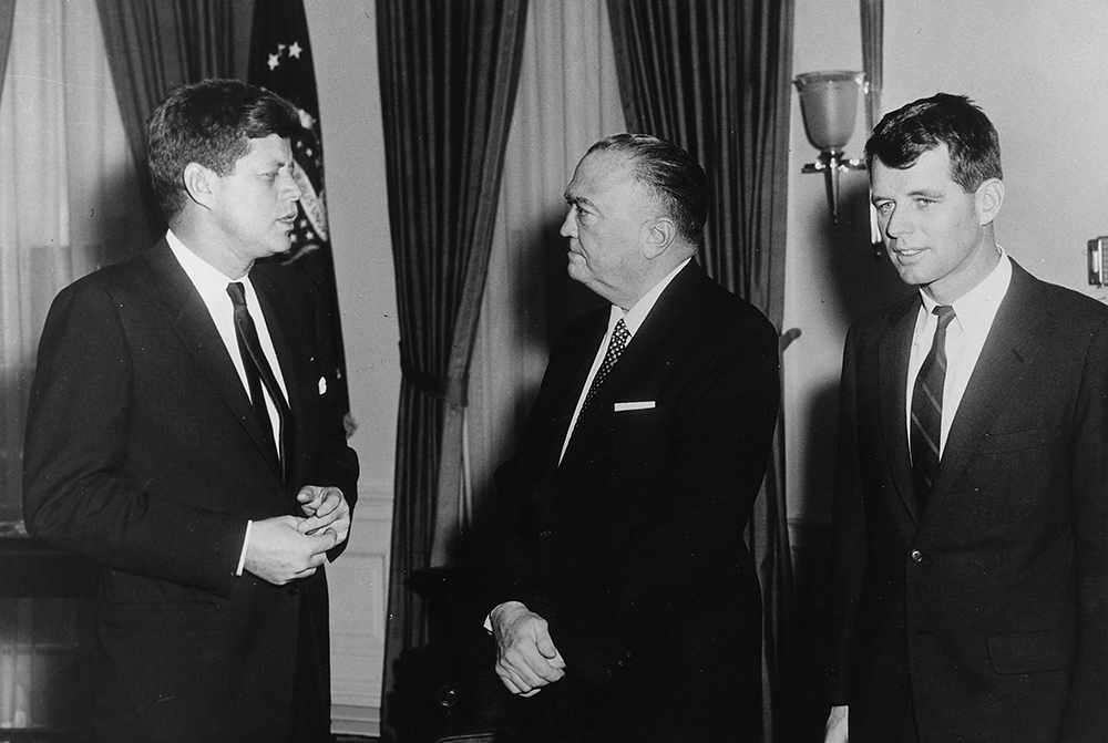 From left, President John F. Kennedy, FBI Director J. Edgar Hoover and U.S. Attorney General Robert F. Kennedy talk in the Oval Office at the White House in Washington, D.C., on Feb. 23, 1961. (Wikimedia Commons/National Archives and Records Administration)