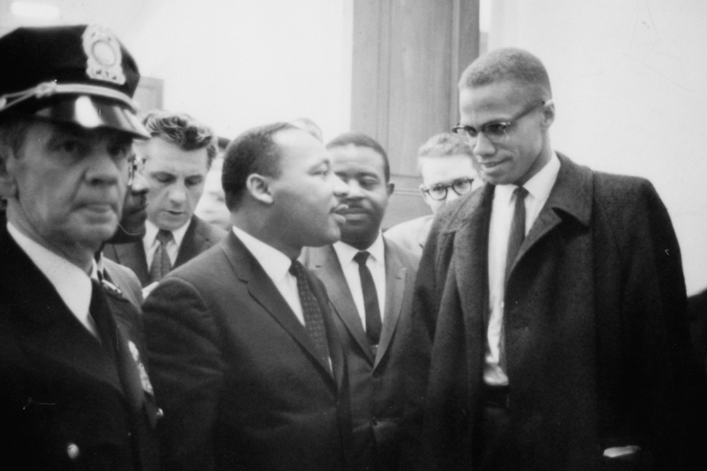 The Rev. Martin Luther King Jr., center, and Malcolm X, right, meet on March 26, 1964, after King's press conference at the U.S. Capitol about the Senate debate on the Civil Rights Act of 1964. (Library of Congress/U.S. News & World Report Magazine Photograph Collection/Marion S. Trikosko)