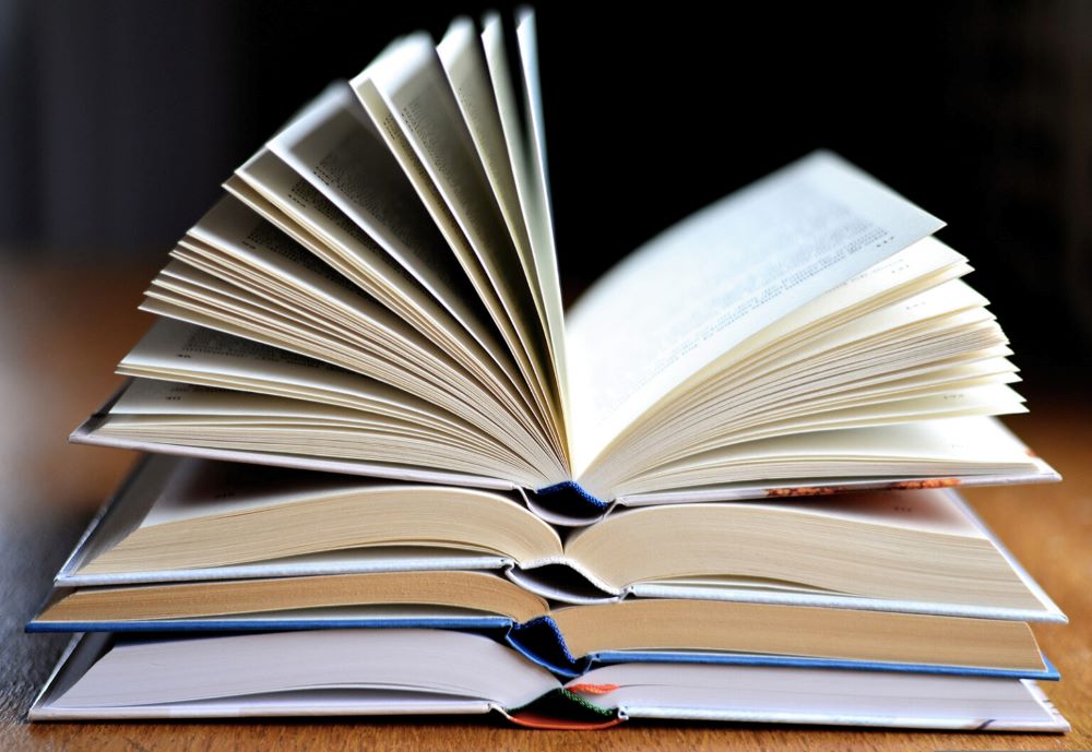 Pile of open books (RNS/Pixabat/Conger Design)