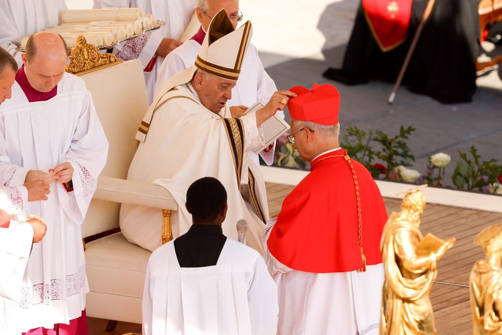 Pope Francis gives the red biretta to new Cardinal Robert Prevost, then the U.S.-born prefect of the Dicastery for Bishops, during a consistory for the creation of 21 new cardinals.