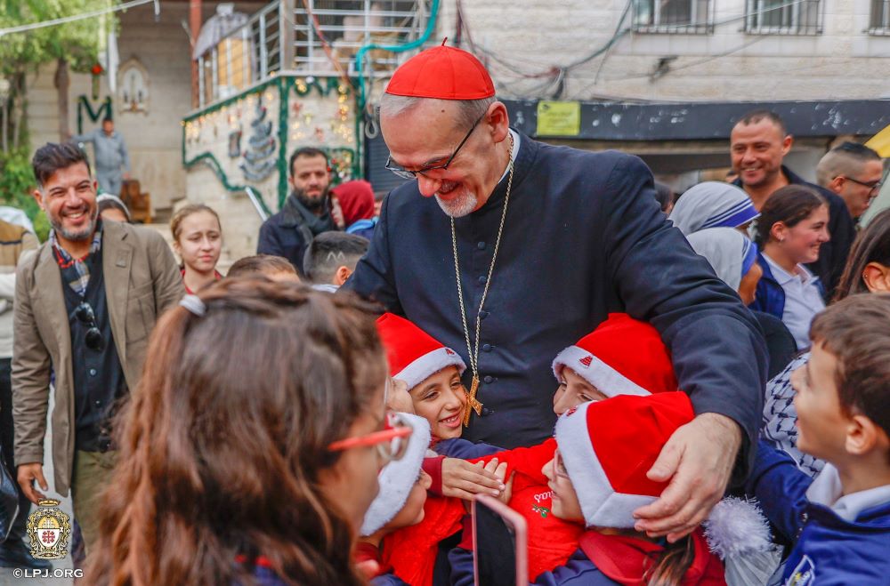 Cardinal Pierbattista Pizzaballa greets children as he visits the compound of Gaza City's Holy Family Parish. 