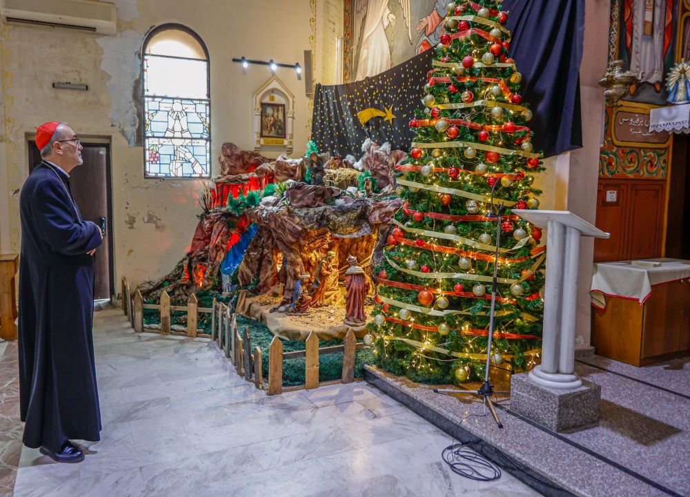 Cardinal Pierbattista Pizzaballa looks at a Nativity and Christmas tree inside Gaza City's Holy Family Church.