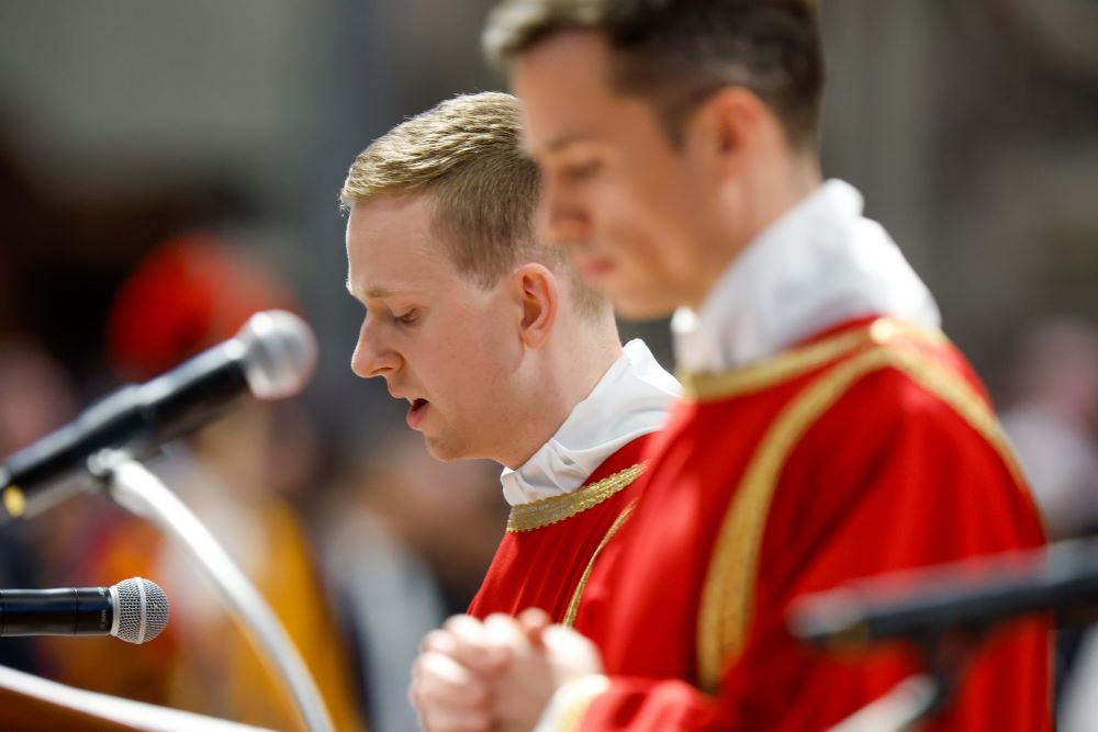 Deacons chant the Gospel account of Jesus' passion during the Good Friday liturgy in St. Peter's Basilica at the Vatican March 29, 2024. 