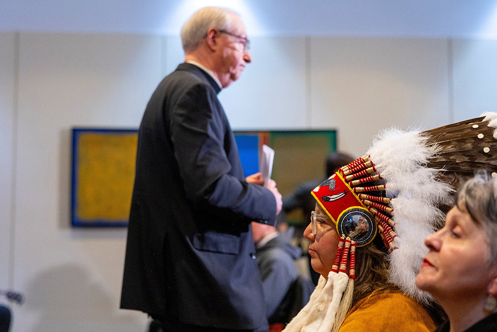 National Chief of the Assembly of First Nations Cindy Woodhouse Nepinak looks on as Archbishop Richard Smith of Vancouver, British Columbia, takes his seat after speaking during a Dec. 6, 2025, news conference in Dorval, Quebec, welcoming 62 cultural artifacts connected to the Indigenous Peoples of Canada, on their arrival from the Vatican. (OSV News/Reuters/Carlos Osorio)