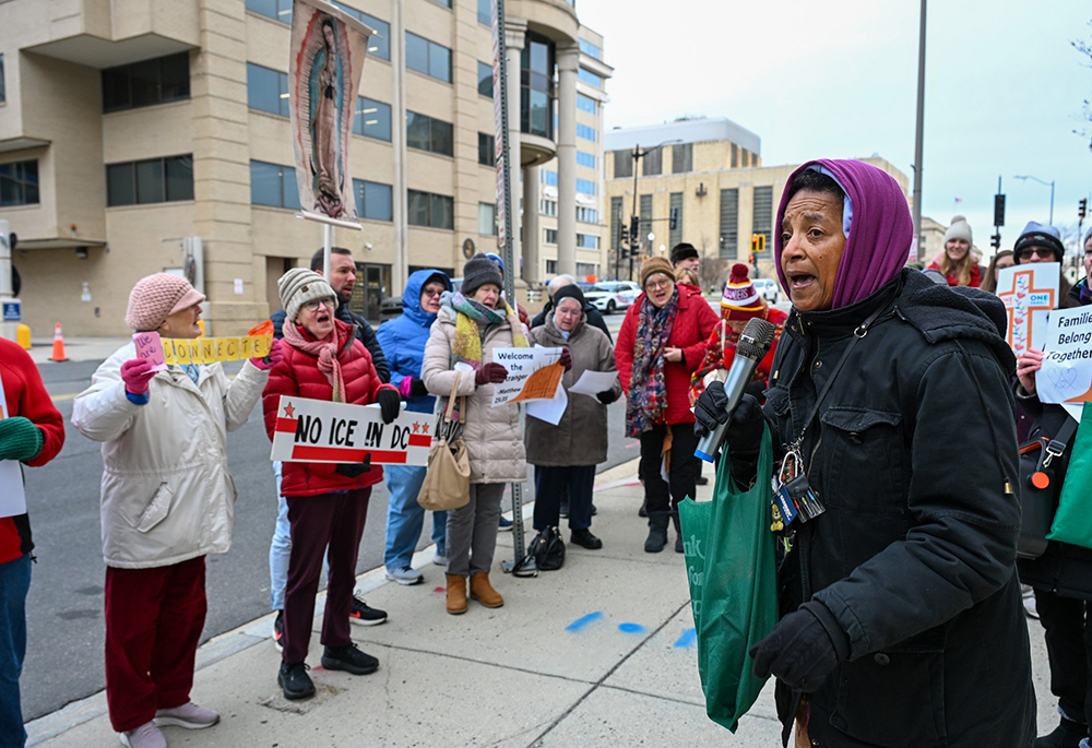 Charlene Howard, executive director of Pax Christi USA, leads community members during a prayer vigil outside the U.S. Customs and Immigration Enforcement headquarters in Washington Dec. 12, 2025. (OSV News/Leslie E. Kossoff)