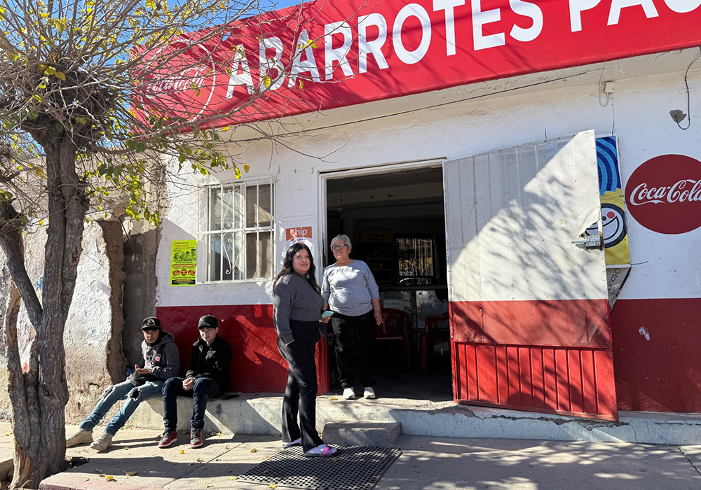 Nogales, Mexico, residents watch a procession of more than 200 people participating in a traditional posada in honor of migrants Dec. 20. (Anita Snow)