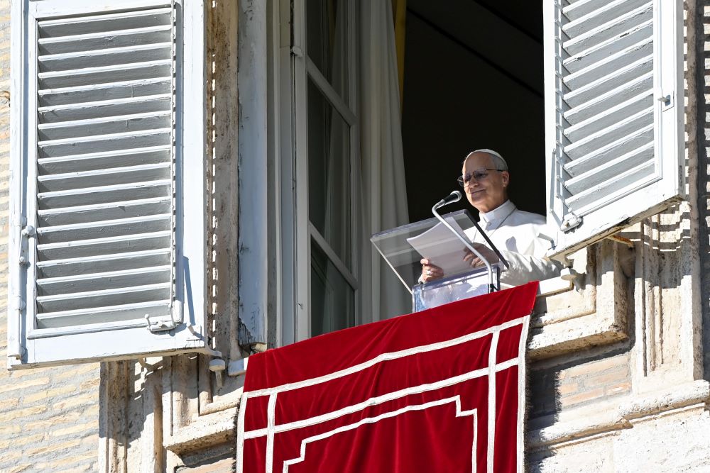 Pope Leo XIV speaks to visitors in St. Peter's Square at the Vatican as they gather to pray the Angelus prayer Jan. 11, the feast of the Baptism of the Lord. The pope prays the Sunday Angelus from the penultimate third-floor window of the Apostolic Palace. (CNS/Vatican Media)