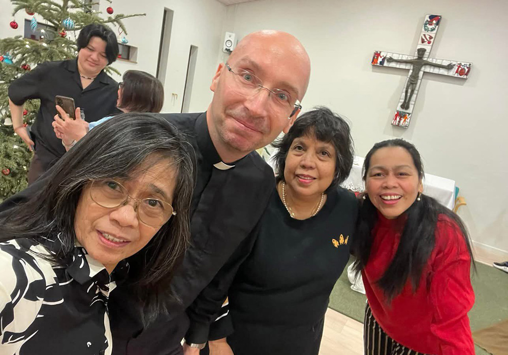 Fr. Tomaž Majcen, a Conventual Franciscan, and the only Catholic parish priest serving in Greenland, is seen with several of his parishioners at Christ the King Church in Nuuk, Greenland. Father Majcen says talks about a U.S. takeover are being met with concern, fear and "a quiet strength" by residents. (OSV News/Fr. Tomaž Majcen)