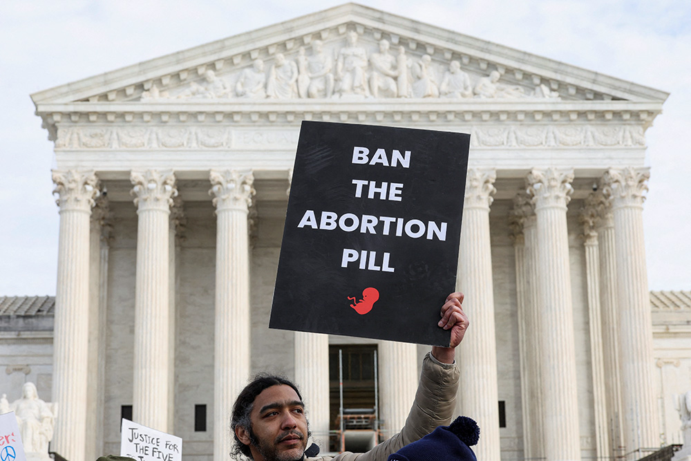 A pro-life advocate holds a sign outside the U.S. Supreme Court during the 53rd annual March for Life in Washington Jan. 23, 2026. (OSV News/Reuters/Kylie Cooper)