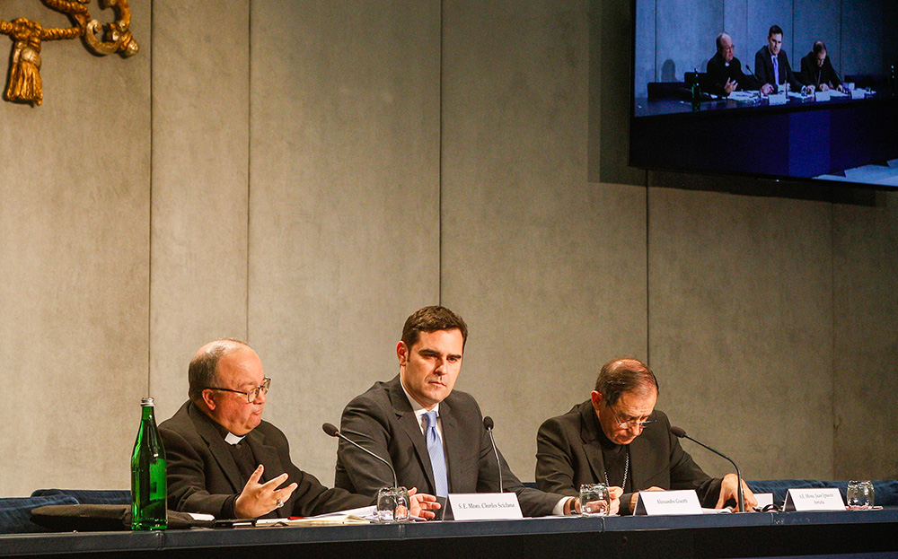 Malta Archbishop Charles Scicluna, left, and Bishop Juan Ignacio Arrieta, right, secretary of the Pontifical Council for Legislative Texts, together with Alessandro Gisotti of the Vatican press office, present Pope Francis' document on abuse norms, Vos Estis Lux Mundi, at the Vatican May 9, 2019. (CNS/Robert Duncan)